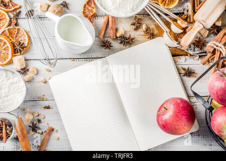 Autumn baking sale concept. Cooking seasonal fall baking background with ingredients, spices, apples, supplies, white wooden table top view copy space Stock Photo