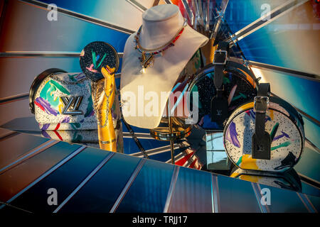 Shoppers with Louis Vuitton bags in Oxford Street London, pass bus with  advert for fashion outlet boohoo Stock Photo - Alamy