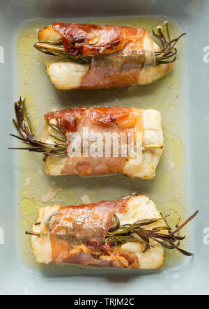 Three cooked fillets of pollack, Pollachius pollachius, that have been ...