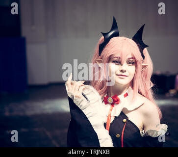 NEC, BIRMINGHAM, UK - JUNE 1, 2019. A female cosplayer dressed as a Japanese Anime character with colourful wig and make up at a comic con event Stock Photo