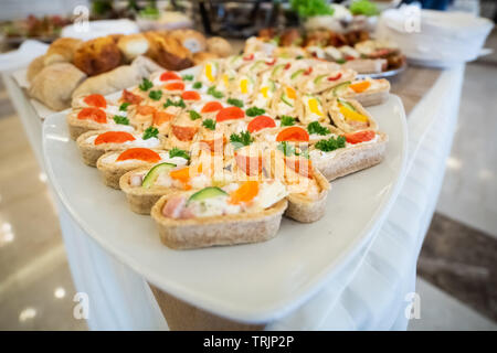 Beautifully decorated catering banquet table with different food snacks and appetizers Stock Photo