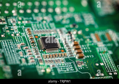 Macro cloes up of a green micro chip computer processor circuit boad. Electroncs technology and macro computer concept background. Stock Photo