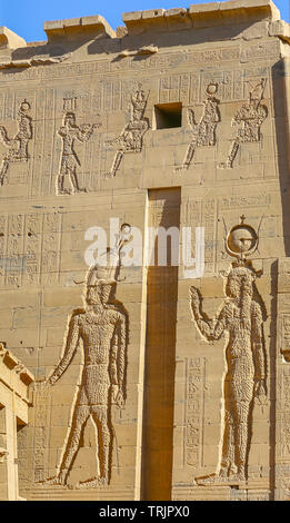 Wall decorations and hieroglyphics of the gods Ra, Osiris and Horus in the Temple of Philae on Agilkia Island in Lake Nasser, Egypt Stock Photo