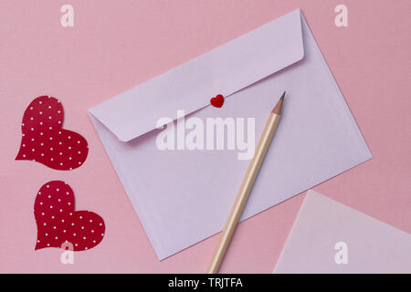 Love letter on a pink background. white paper envelope mock up. love correspondence concept Stock Photo