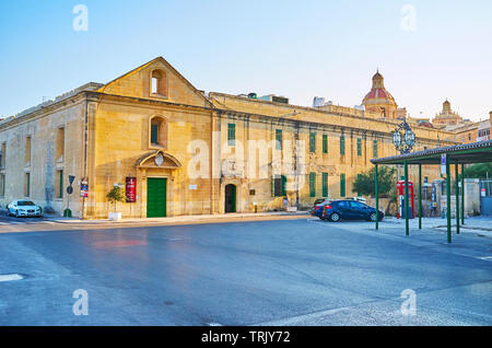 VALLETTA, MALTA - JUNE 19, 2018: The medieval building of former hospital, nowadays became Mediterranean Conference Centre, on June 19 in Valletta. Stock Photo