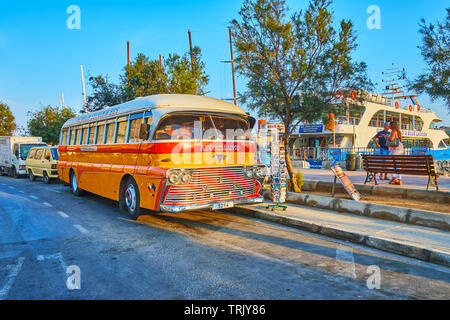 SLIEMA, MALTA - JUNE 19, 2018: The vintage AEC-Reliance bus, parked at the seaside promenade, serves as the souvenir store and attracts the tourists,