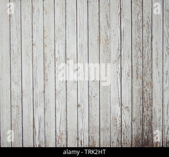 Abstract background of old painted white boards. From time, old age and dampness paint crumbles. Stock Photo