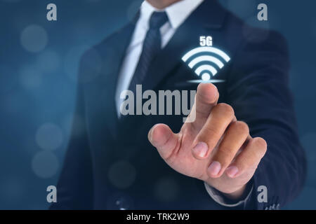 business man point hand to wifi 5g sign on Stock Photo