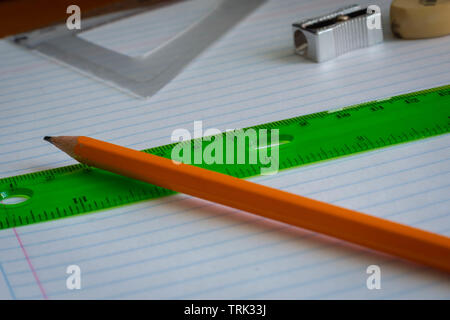 Pencil and rule on a notebook close up Stock Photo