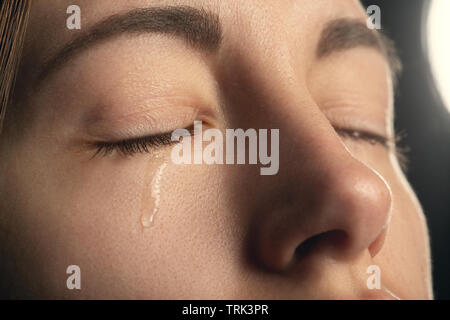 sad sad woman crying, closed eyes, closeup portrait Stock Photo