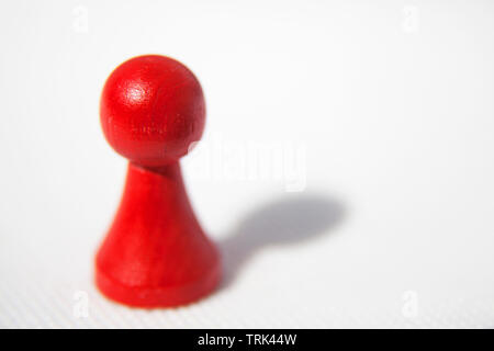 a red game piece on white background Stock Photo