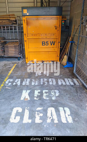 Cardboard baler for recycling and a big keep clear on the ground sine Sydney Australia work site Stock Photo