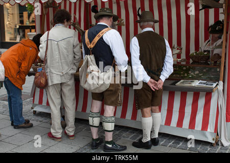 Two men wearing traditional bavarian costume on the street market Stock Photo