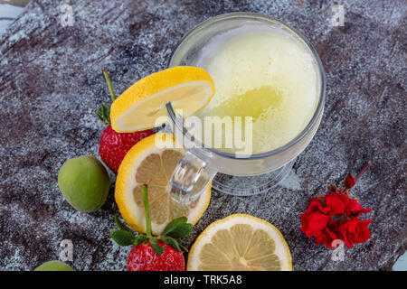Lemonade with ice. Fresh lemonade with strawberry, mint shot top down on rustic table. Stock Photo