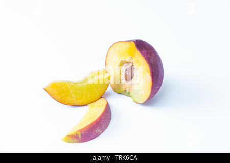 Isolated nectarines. A half nectarine peaches and two small slices isolated on white background Stock Photo
