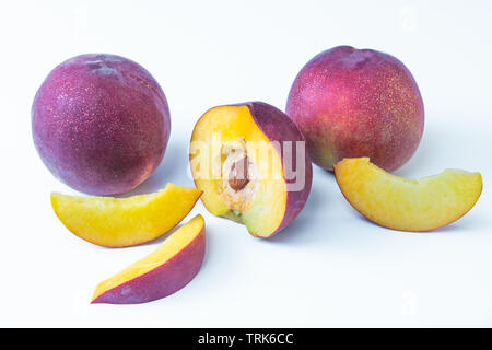 Two nectarines and one sliced nectarines isolated on white background. Texture and color Stock Photo