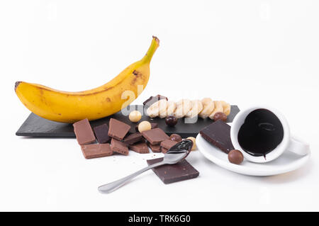 Fresh banana, a banana in slices, bars of chocolate on a white background. Stock Photo