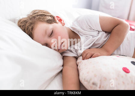 3 years toddler boy sleeping the siesta on bed. Selective focus Stock Photo