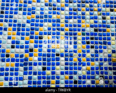 Fragment of beautiful mosaic on the facade of the building. Abstract colored ceramic puzzles as decorative background. Stock Photo