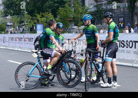 Group of cyclists standing in front of the start line. Cycle race among amateurs devoted to Day of Kiev. May 25, 2019. Kiev, Ukraine Stock Photo