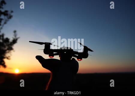 Drone launching from hand at night Stock Photo