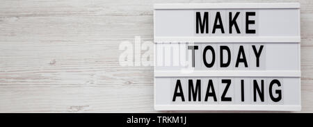 'Make today amazing' words on a modern board on a white wooden background, top view. From above, overhead, flat lay. Copy space. Stock Photo