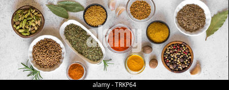 Various Spices on white background. Assortment, set of spices and condiments with vintage pepper mill, top view, banner. Stock Photo