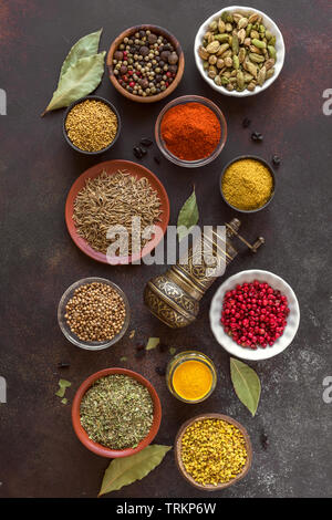 Various Spices on dark background. Assortment, set of spices and condiments with pepper mill, top view, flat lay. Cooking food concept. Stock Photo