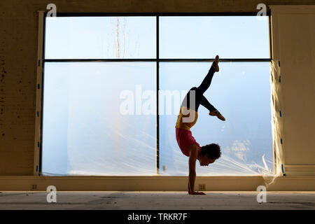 African American female practicing yoga in an old warehouse. Stock Photo