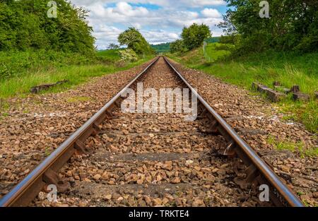 Parallel Railway tracks part of the North Yorkshire Moors heritage railway converging as they recede in to the distance Stock Photo