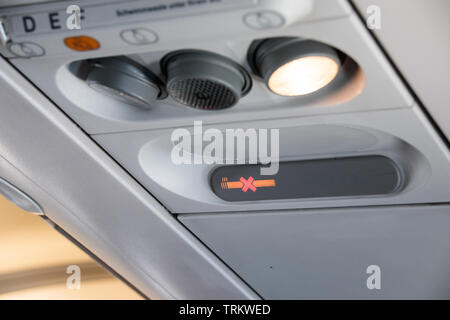 Aircraft passenger cabin lights, warning lights, and seat lettering Stock Photo