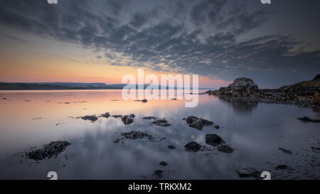 Dusk at low tide on Browns Bay, Islandmagee, County Antrim, Northern Ireland. Stock Photo