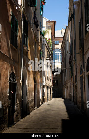 Picturesque narrow alley nobody in Albenga, Liguria, italy. Stock Photo