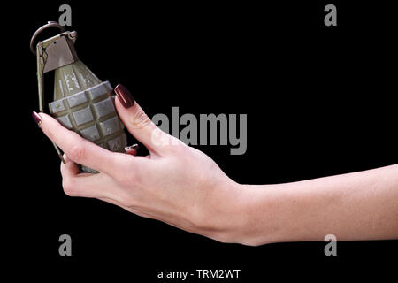 hand grenade in girl hand on black background Stock Photo