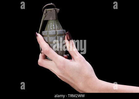 hand grenade in girl hand on black background Stock Photo