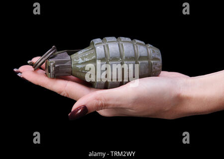 hand grenade in girl hand on black background Stock Photo