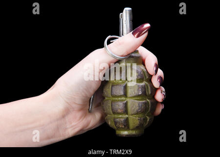 hand grenade in girl hand on black background Stock Photo