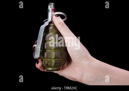 hand grenade in girl hand on black background Stock Photo