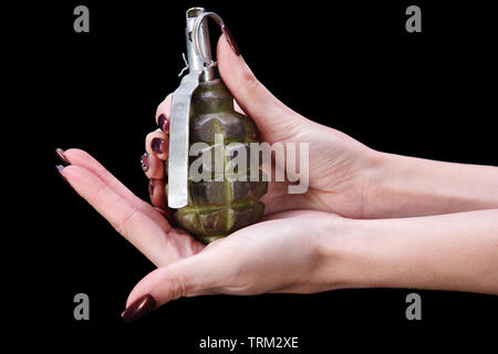 hand grenade in girl hand on black background Stock Photo