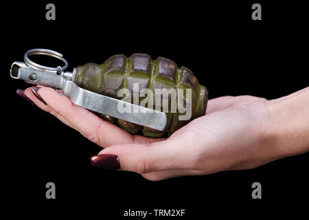 hand grenade in girl hand on black background Stock Photo