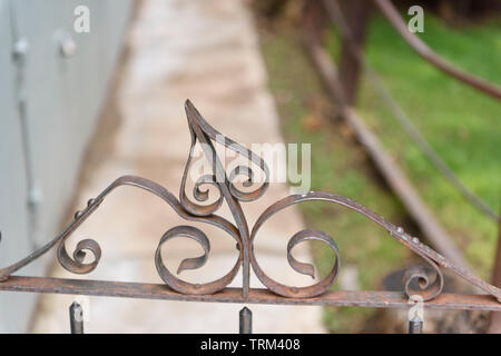 Bisbee, AZ/USA - 03-13-2019:  Close up on the metal Filigree on a fence post. Stock Photo