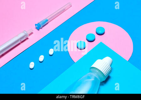 Medical staff and pills minimalistic flat lay on a paper blue and pink colored background. Healthcare concept. Stock Photo