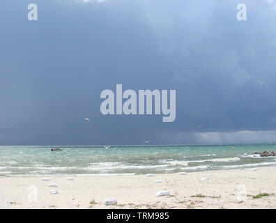 Cloudy sky over the sea. Still life landscape of a stormy sky over sea on a day with sun rays filtering through the moody clouds, nature exterior. Cha Stock Photo