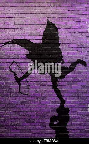 Vertical image of purple brick wall with the painting of cupid's silhouette Stock Photo