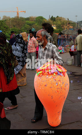 an old man selling balloons on the streets Stock Photo