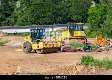 HANOVER / GERMANY - JUNE 2,2019: Yellow construction vehicles stands on a construction site in Hanover. Stock Photo