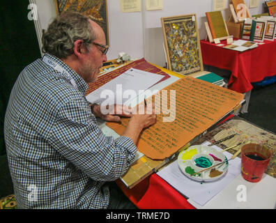 London, UK. 09 th June, 2019. Andy Moore doing some calligraphy at The London's  First Rare Book Fair, . Paul Quezada-Neiman /Alamy Live News Stock Photo
