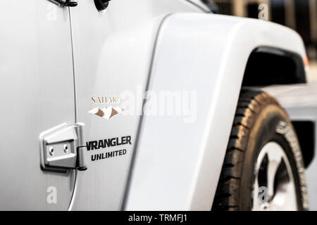 The side of a silver 2017 Jeep Wrangler Sahara. Stock Photo