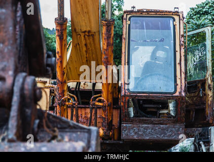 abandoned rusty and old excavator on the beach Stock Photo