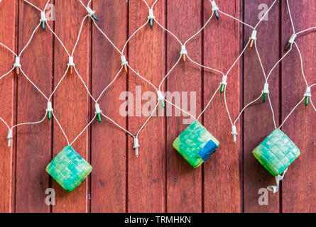KETUPAT Net Light Led display on wood board background Stock Photo